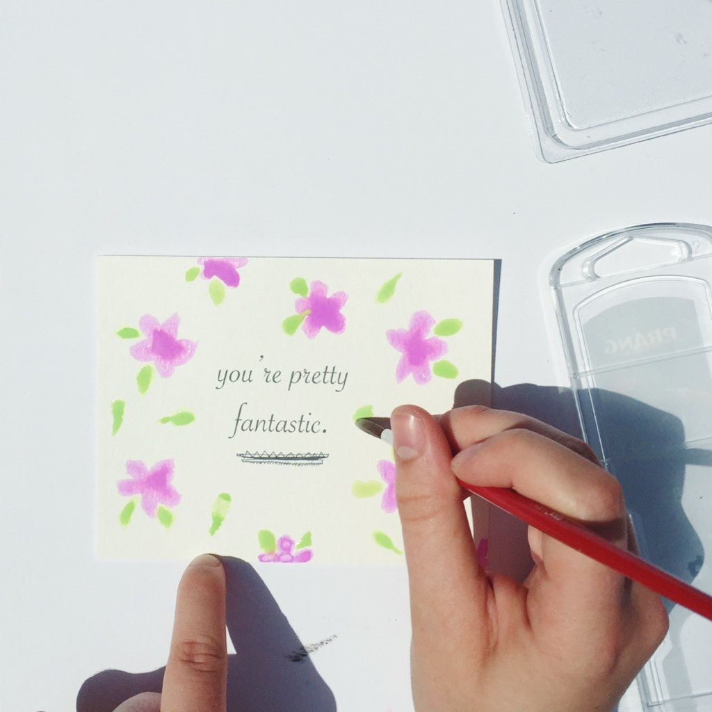 painting a postcard with purple flowers