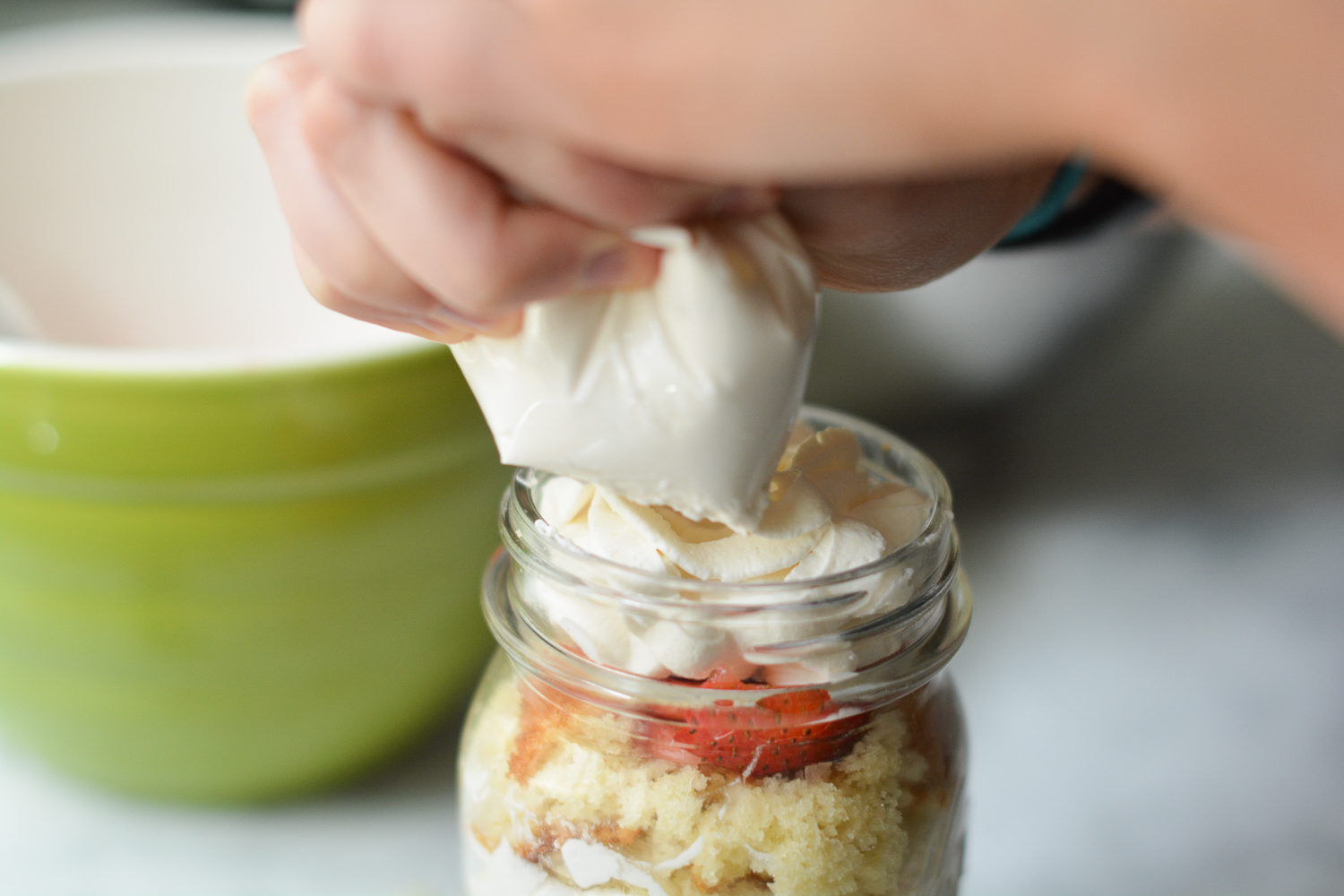 adding the cream to the cake in a jar!