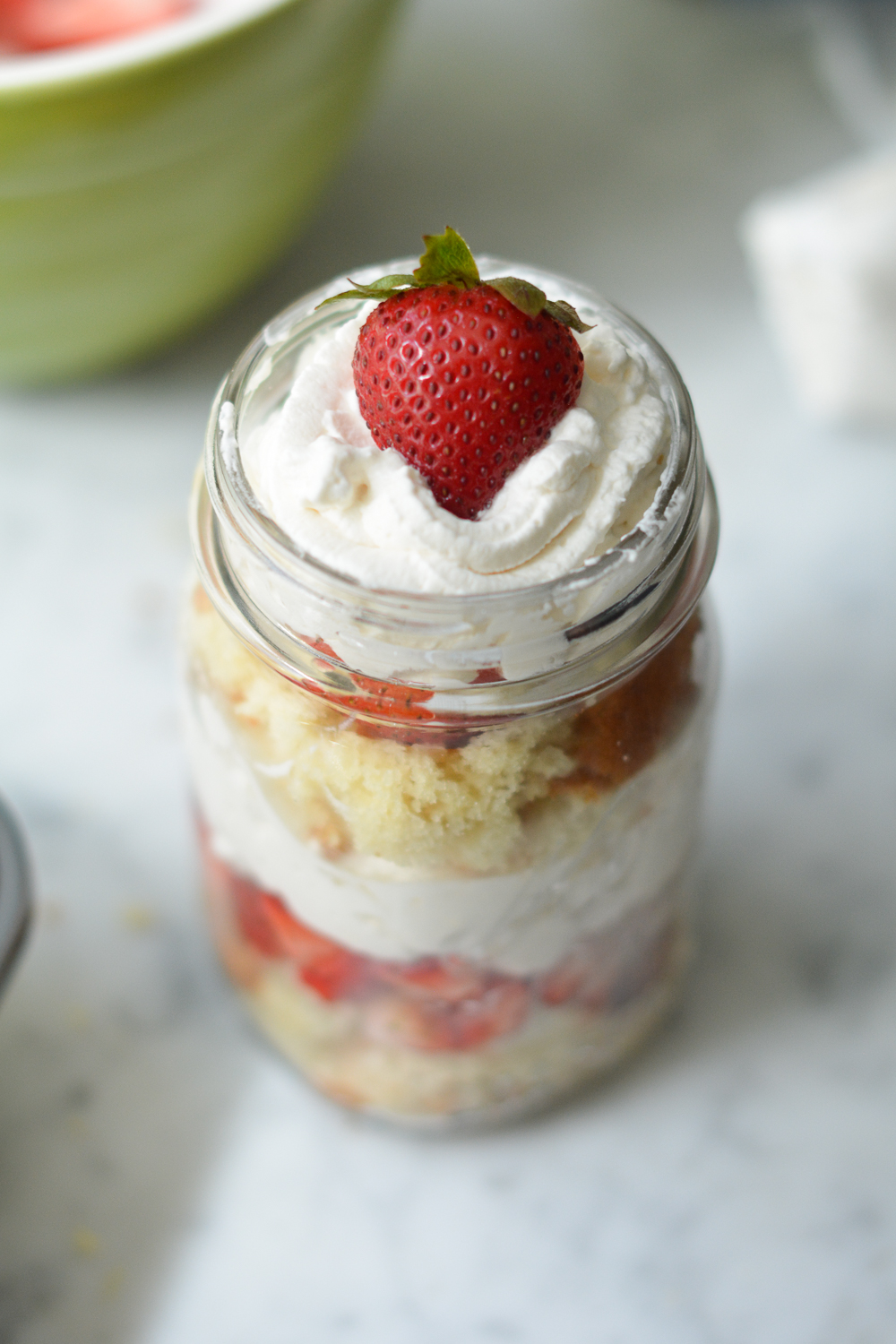 finished cake in a jar with a strawberry on top