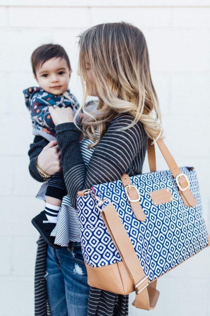 carrying my blue and tan austin fowler diaper bag