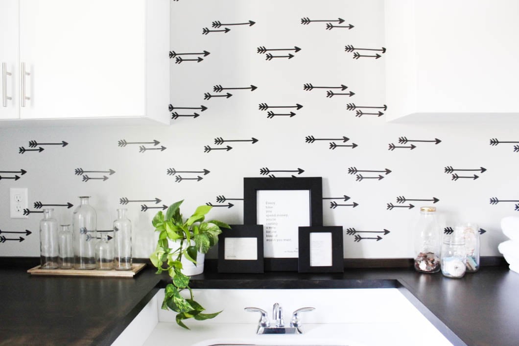 Laundry room decor featuring a faux arrow DIY wallpaper accent wall.