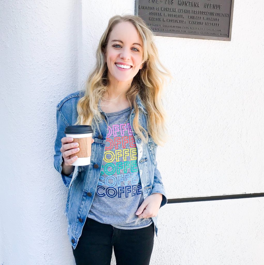 coffee graphic tee, distressed denim jacket and black skinny jeans.