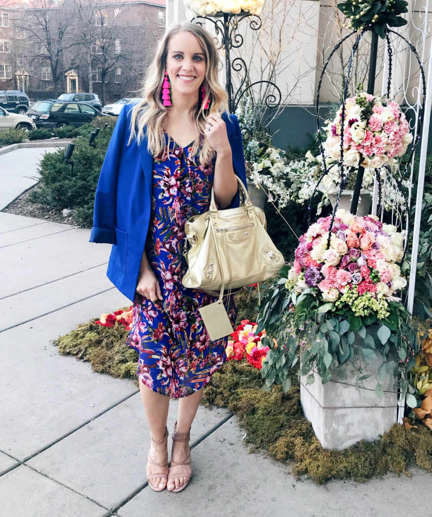 blue spring outfit with pink tassle earrings, floral dress, blue blazer and gold balenciaga bag
