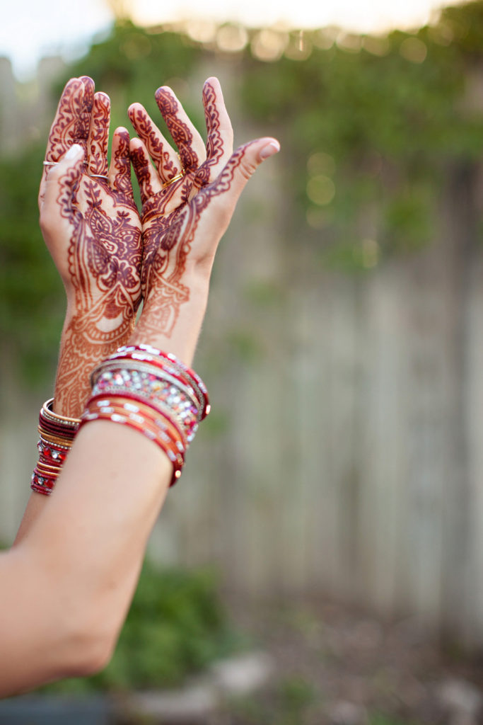 Woman's hands covered in mehndi