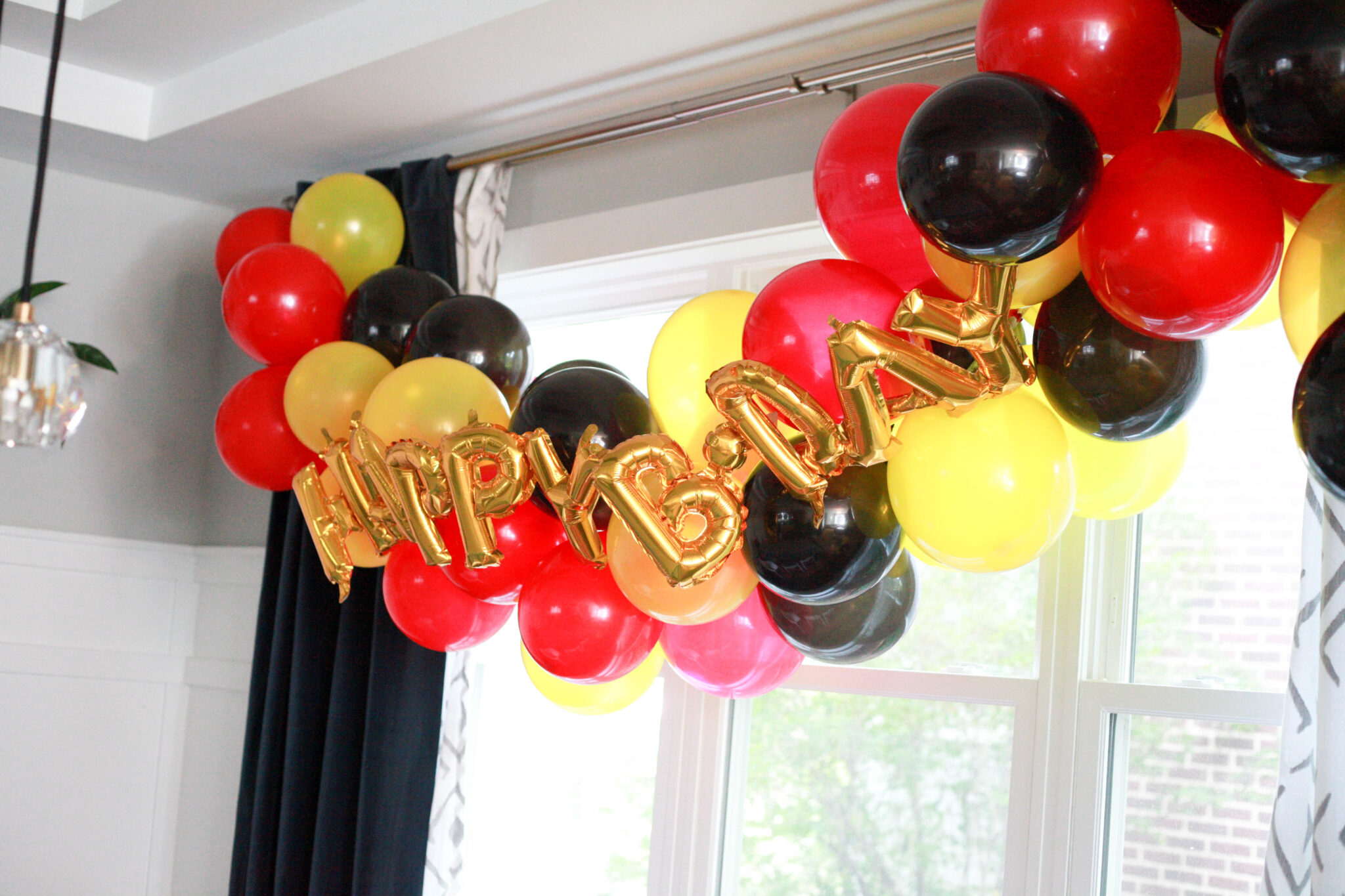 diy red black and yellow balloon arch for mickey mouse birthday