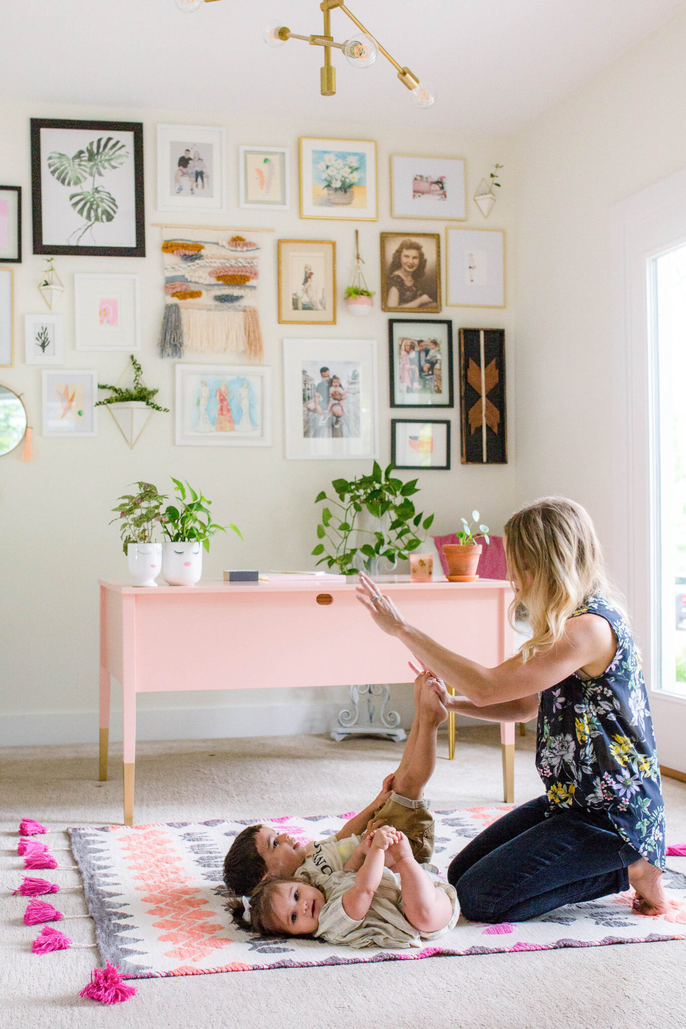 Woman playing with kids in feminine home office