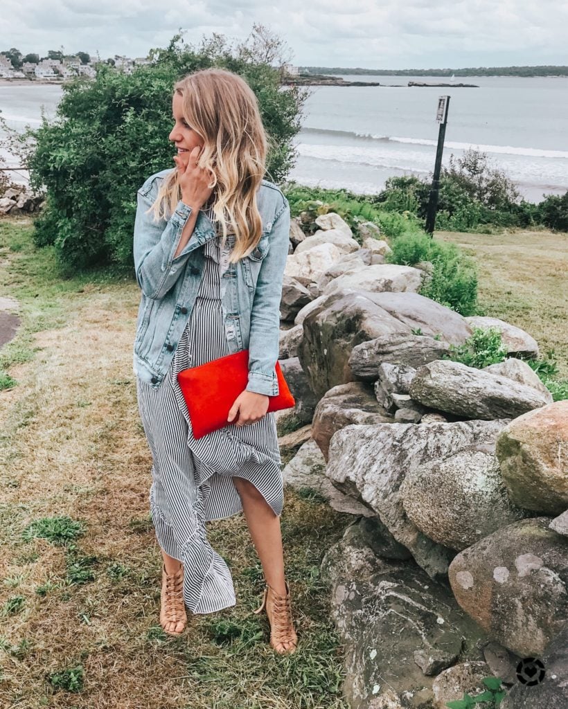 Woman wearing a denim jacket over a dress