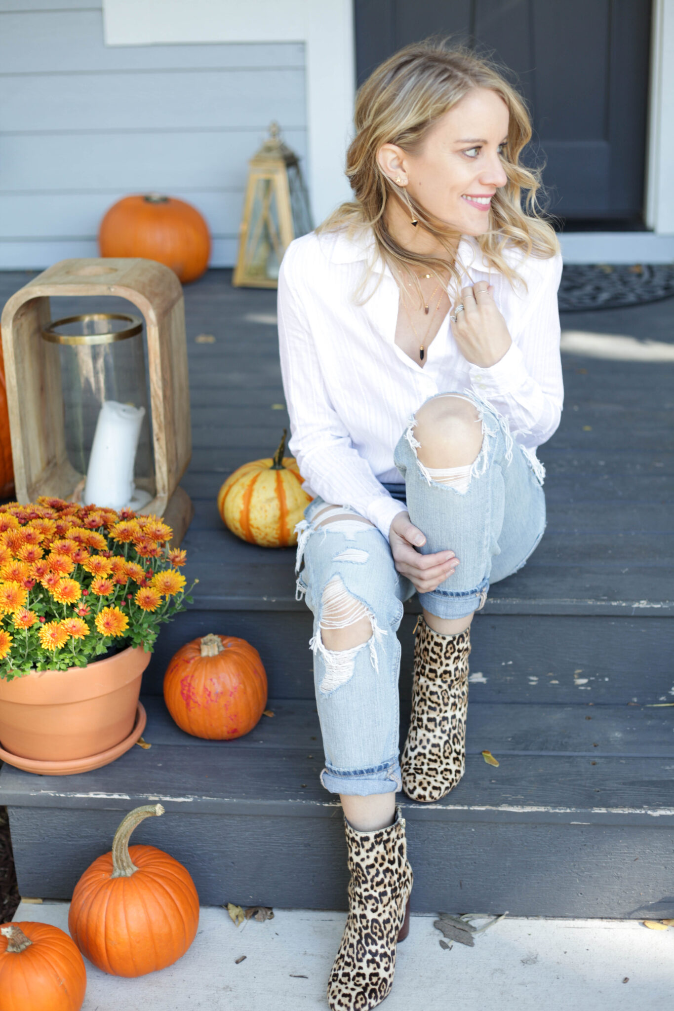 White button down with distressed denim and leopard print boots