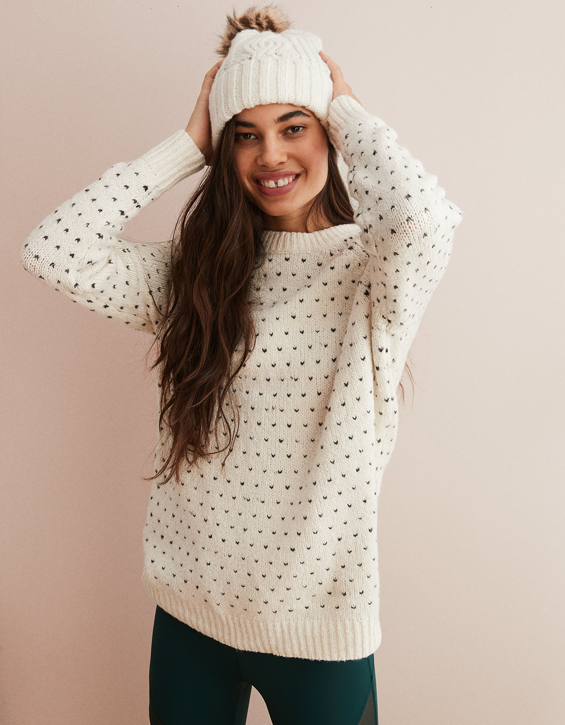 Woman in white and black sweater and white knit hat