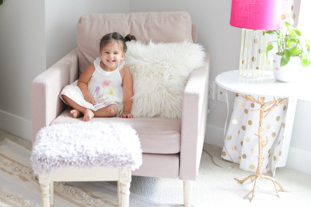 Toddler in light pink armchair 