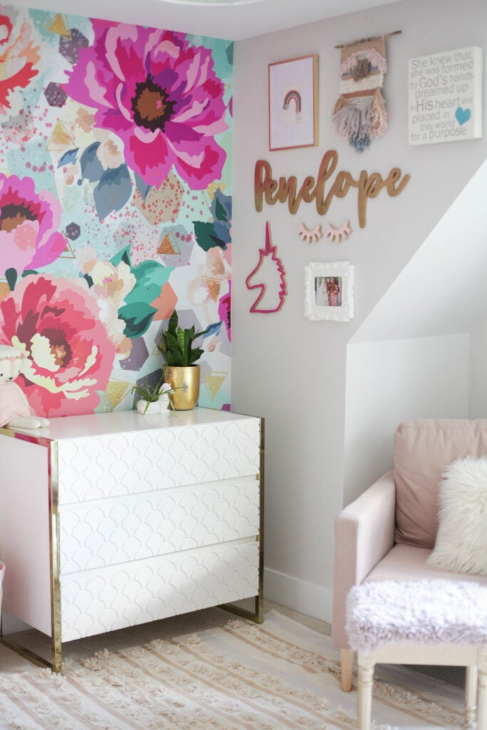 bright and bold floral wallpaper with fun gallery wall and white and gold dresser