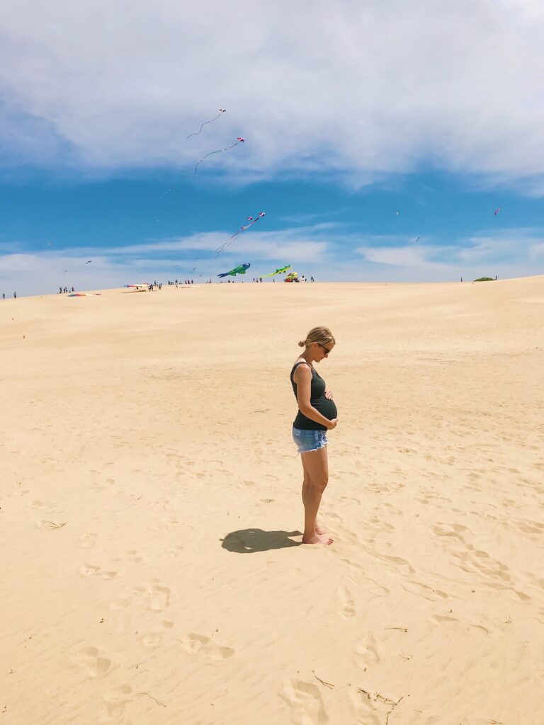 pregnant woman on sand dunes