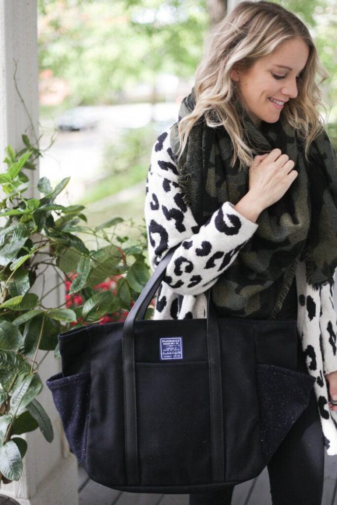 a woman carrying a faribault utility tote