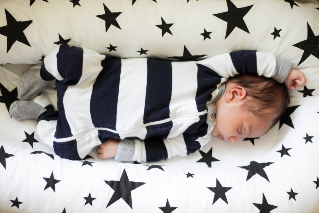 baby in dock a tot wearing burts bees pajamas