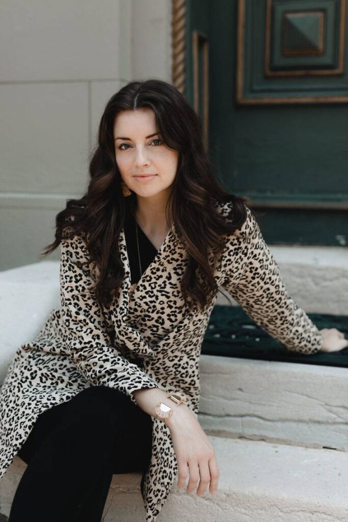 Model wearing leopard jacket over black dress