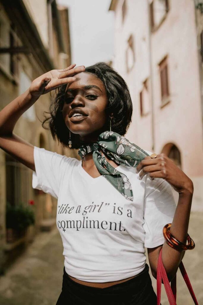 Woman wearing "like a girl" t-shirt and scarf