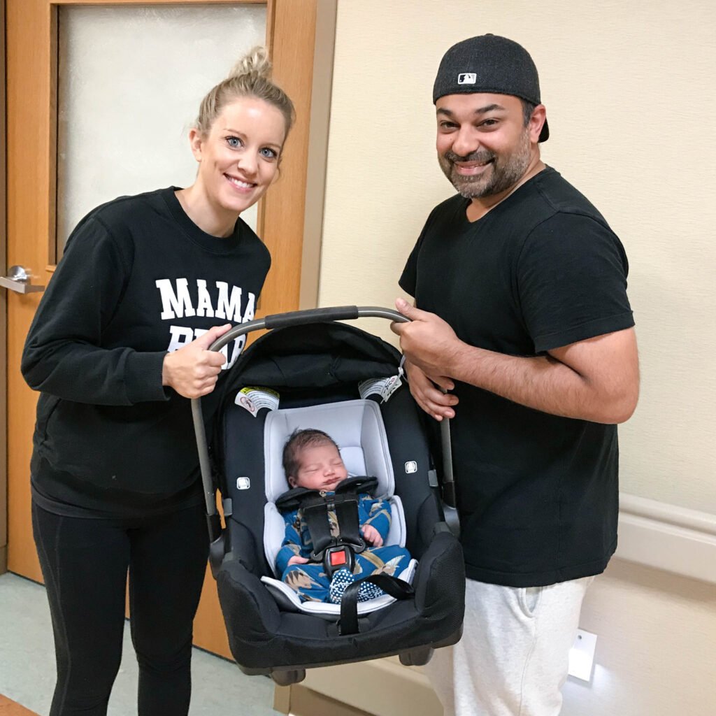 Parents with newborn in carseat