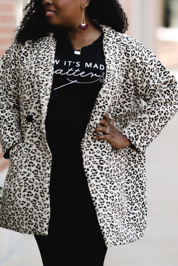 Model wearing leopard jacket over black t-shirt