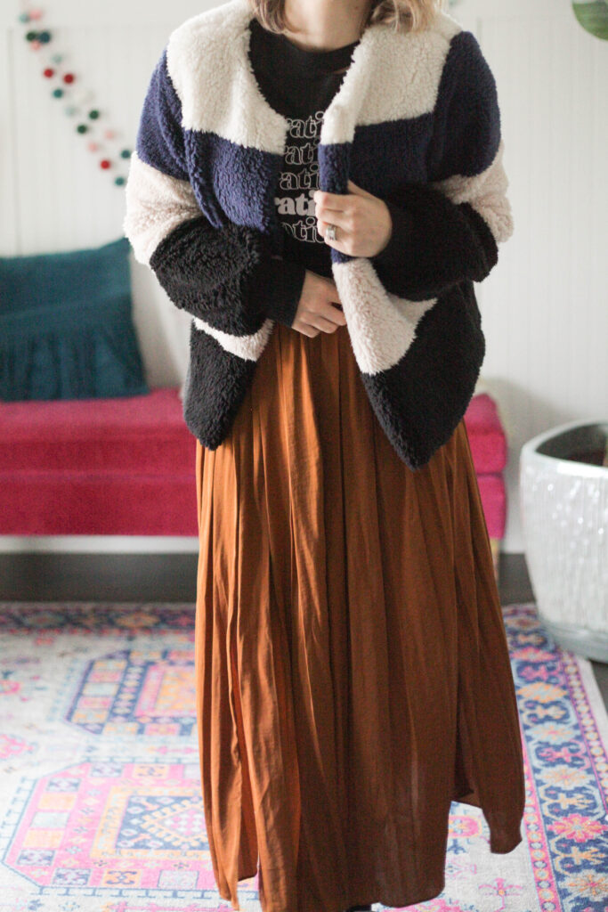 Midi skirt with graphic tee and striped sherpa jacket