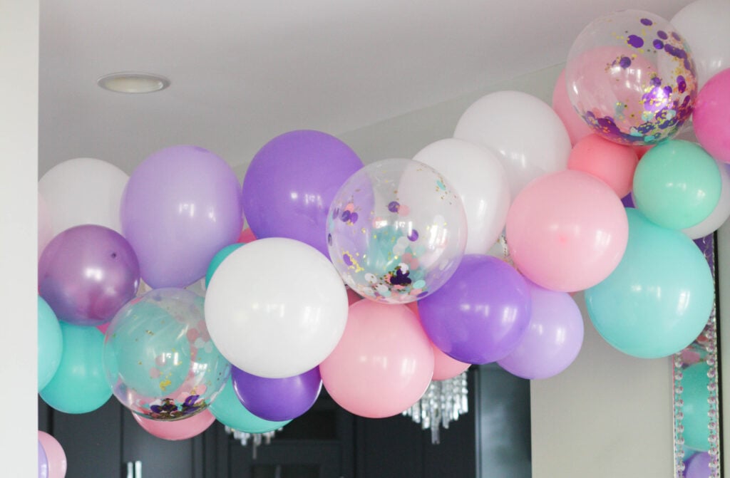 Pink, purple, teal and confetti balloons for a unicorn theme birthday party