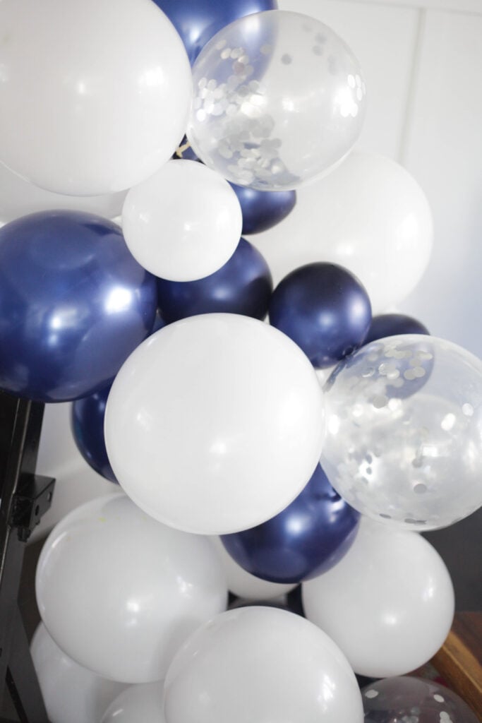 Lots of navy, white and silver confetti balloons