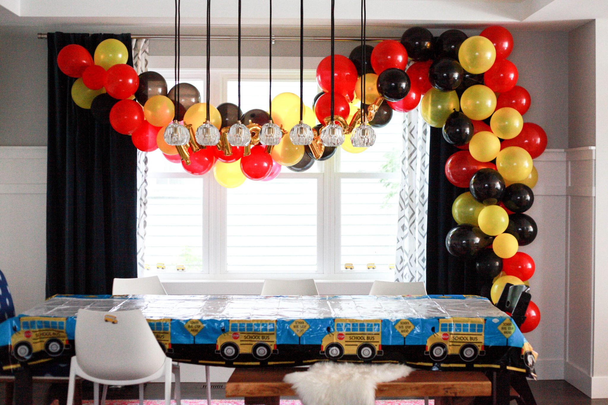 Red, black and yellow balloon arch for a Mickey Mouse birthday party for a 2 year old.