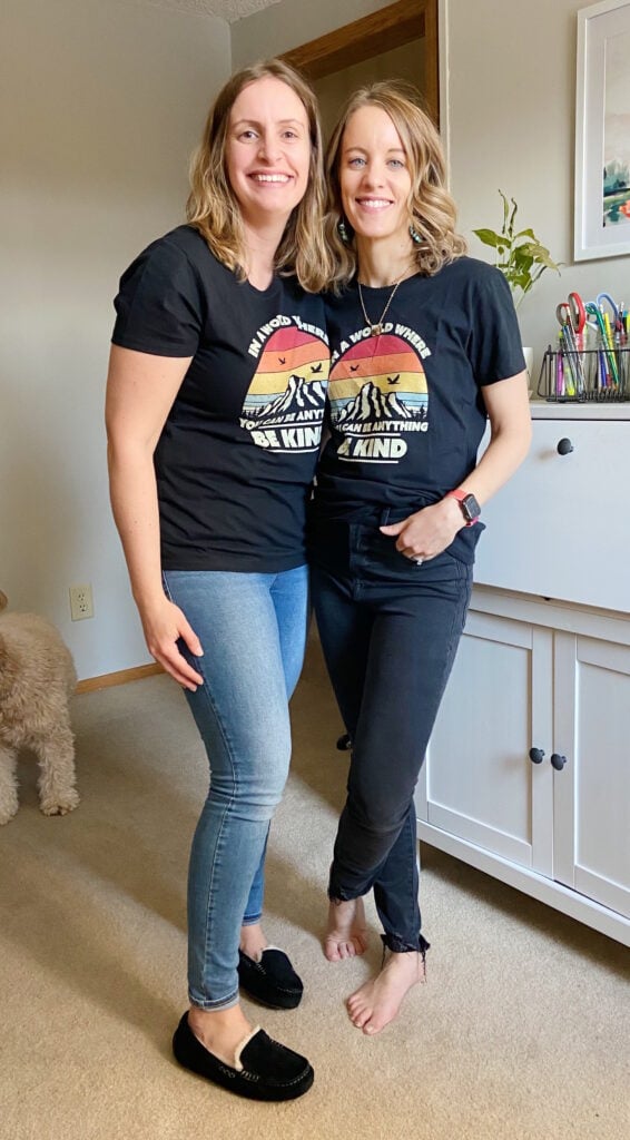 Two women wearing Be Kind tee