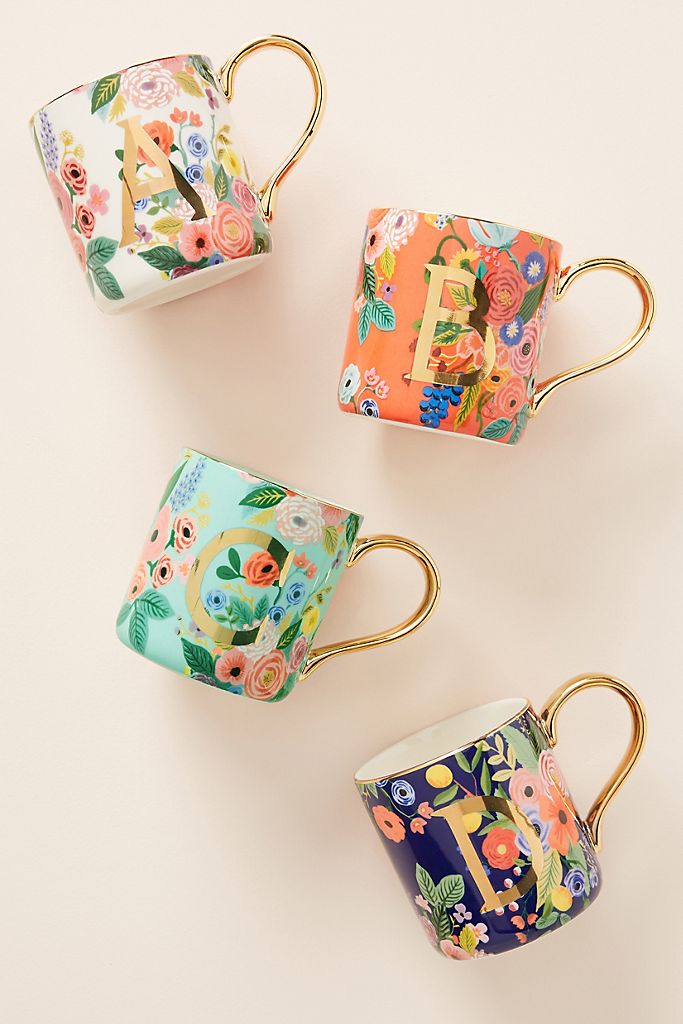 Floral print coffee mugs with letters on them