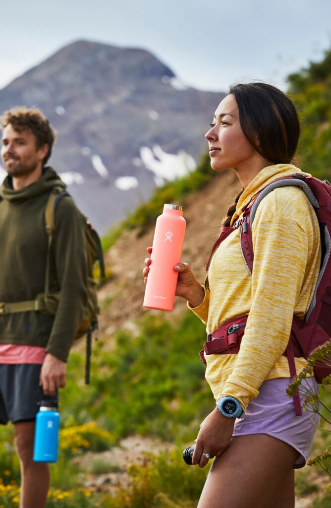 People hiking holding HydroFlask