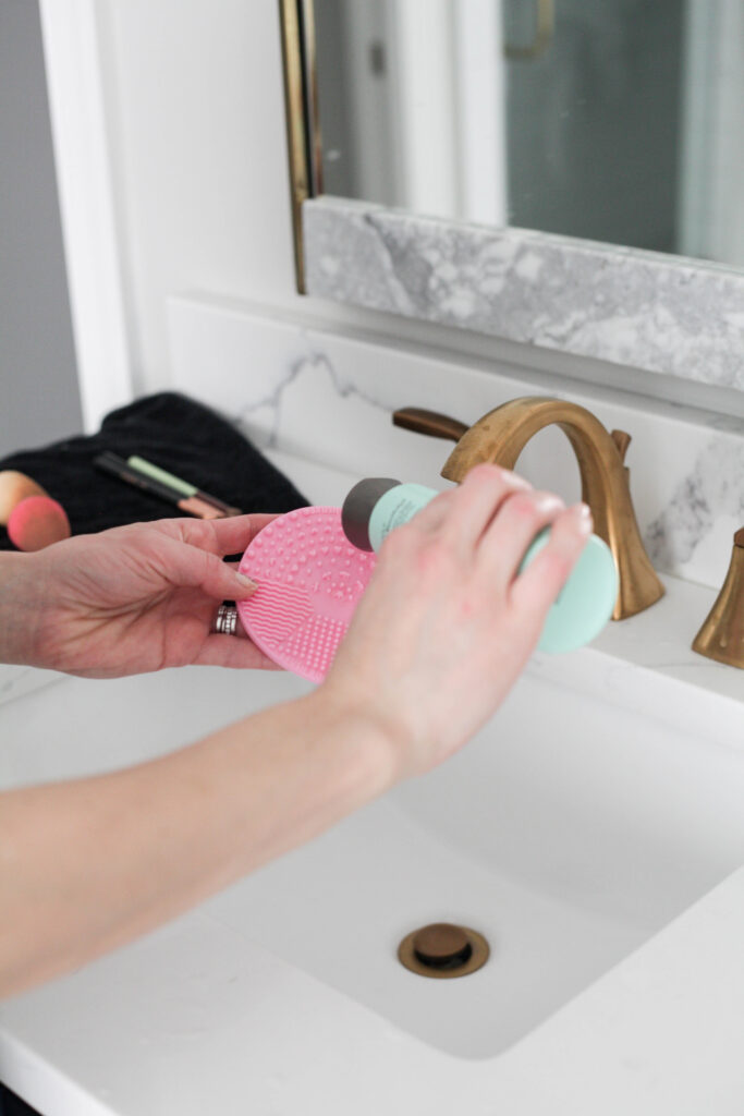 Pour a small amount of soap onto hand or cleaning mat