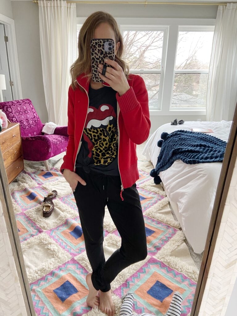 Women in joggers, graphic tee, red sweater