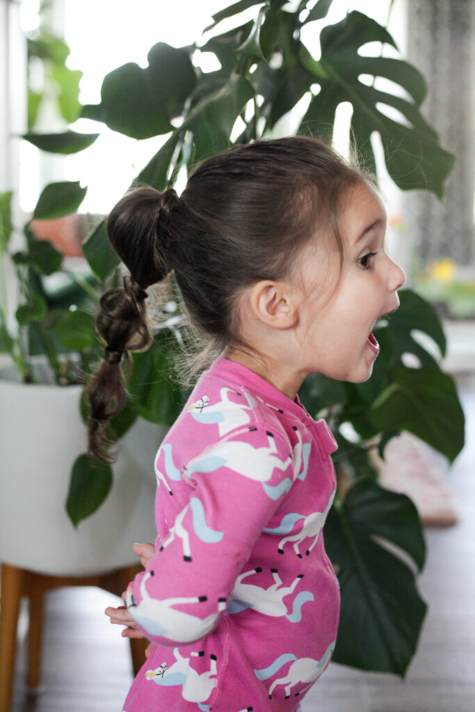 a little girl with a bubble ponytail