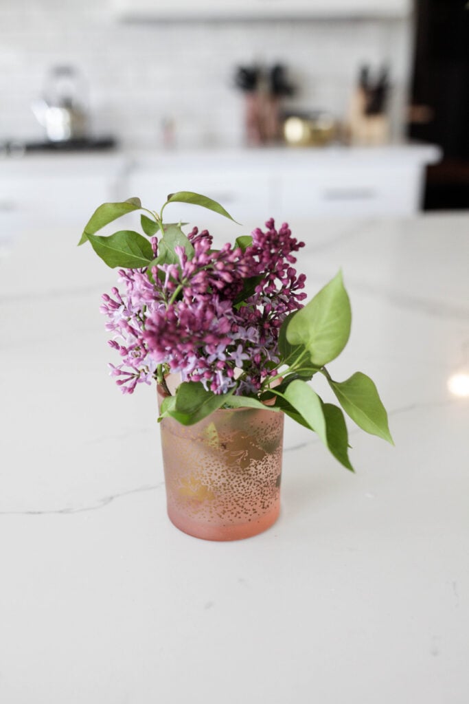 A candle jar used as a vase