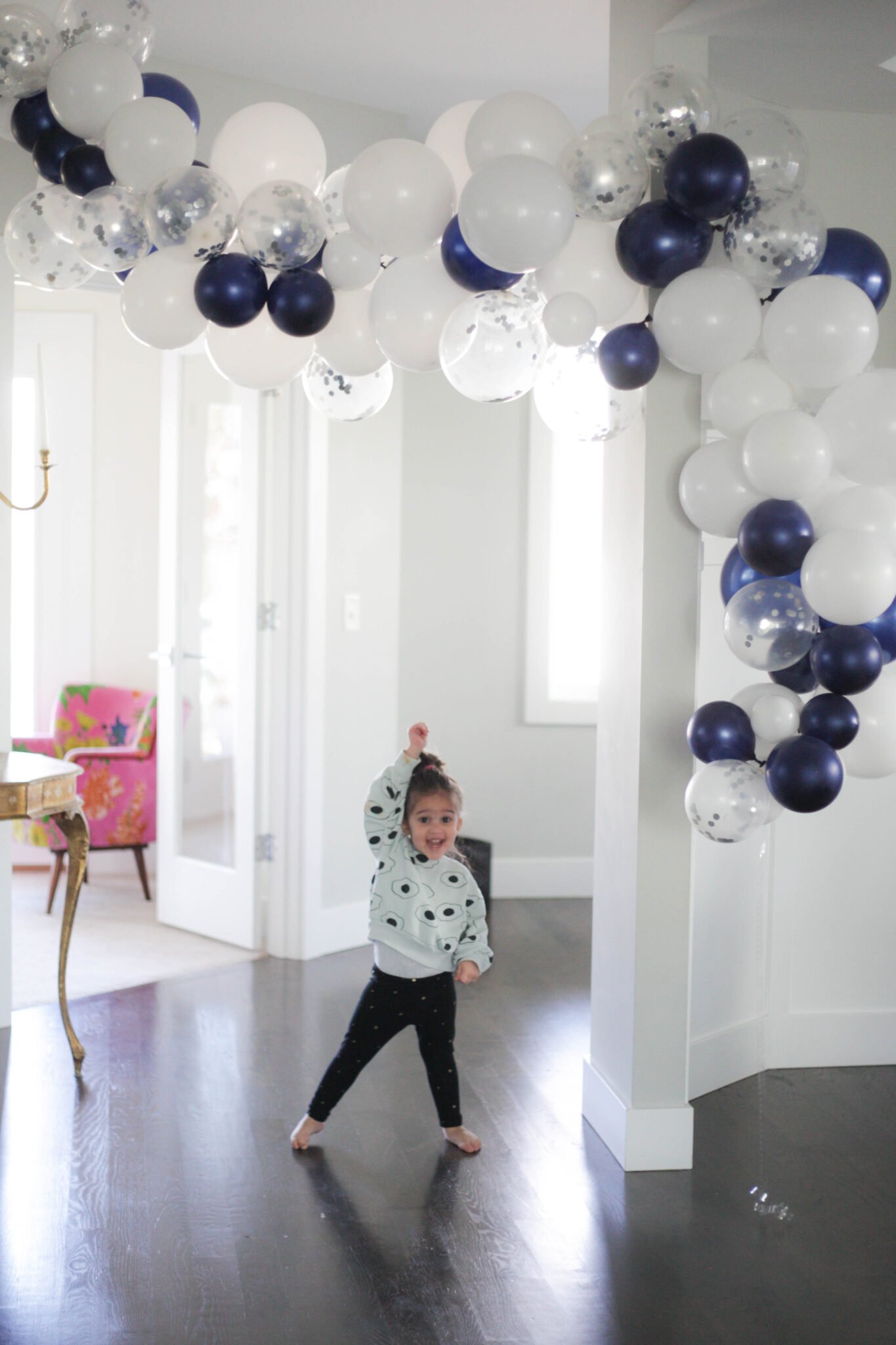 Long navy and white balloon garland over a doorway