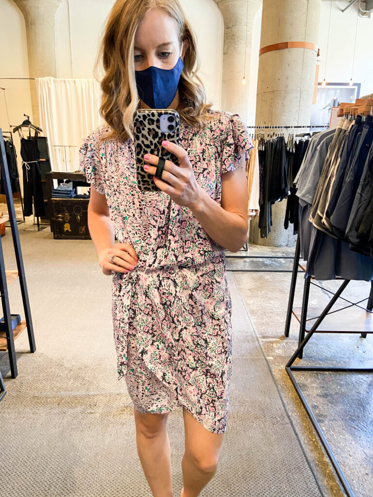 Woman trying a dress on in store wearing mask