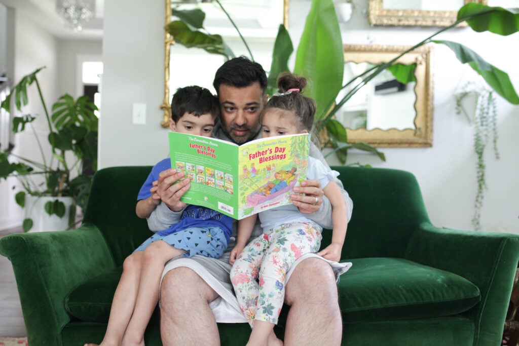 Man reading Berenstain Bears Father's Day Blessings to two kids
