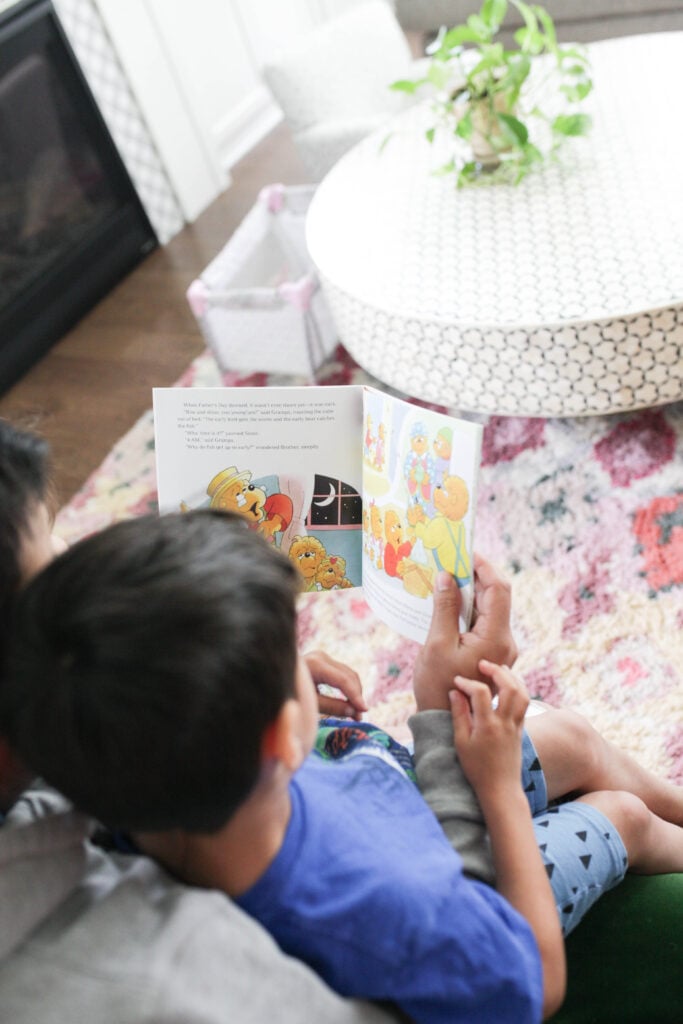 Man reading Berenstain Bears Father's Day Blessings to two kids