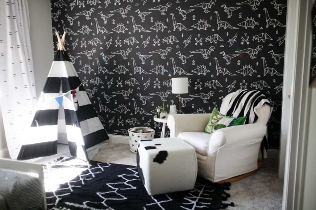 Modern dinosaur kids room with geometric dinosaur wallpaper, black and white tent