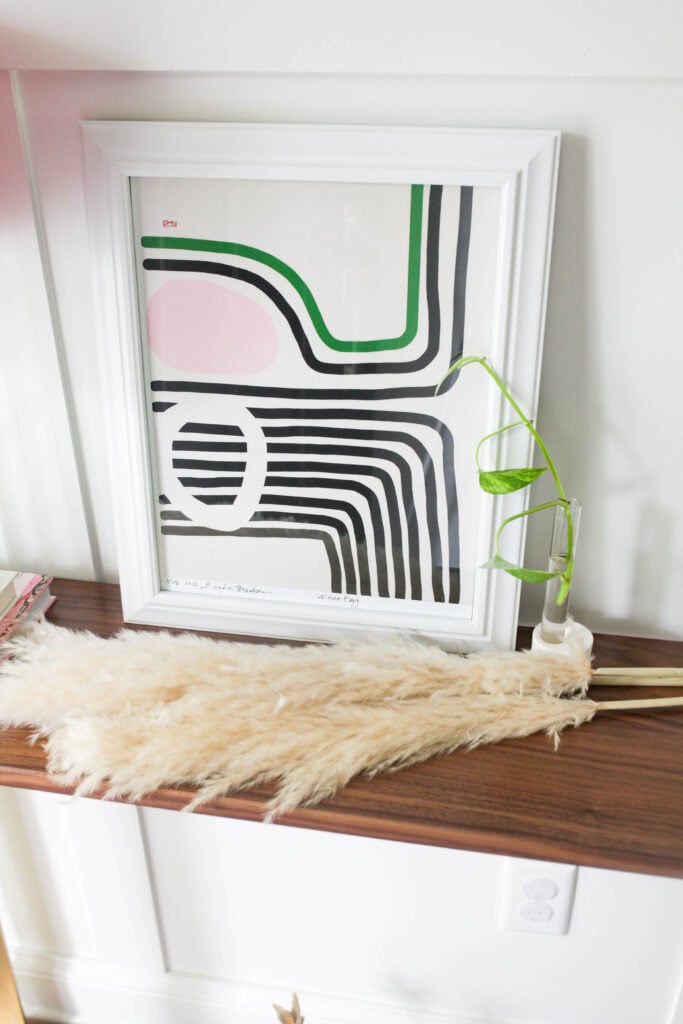 Frame and pampas grass on console table