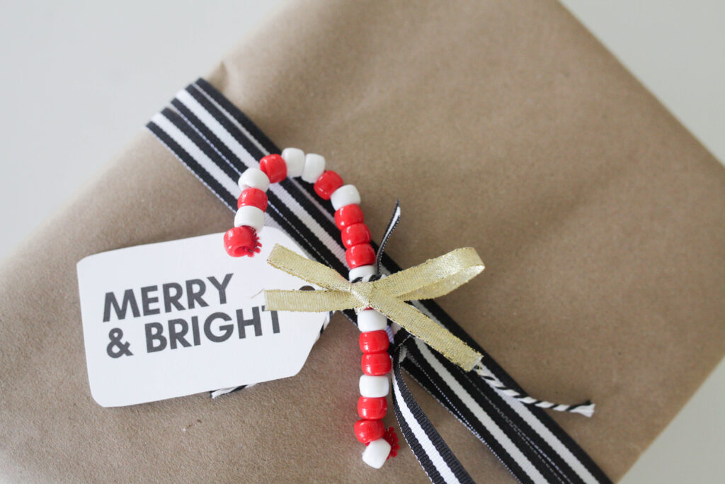 Pipe cleaner candy cane on wrapped package