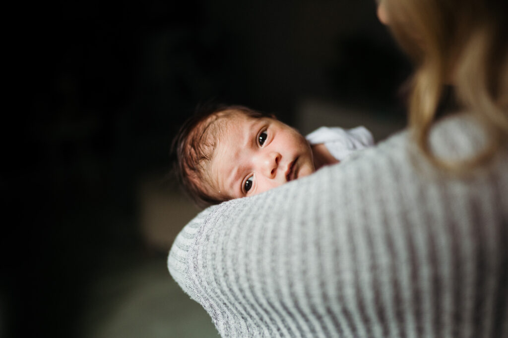 Newborn over mom's shoulder