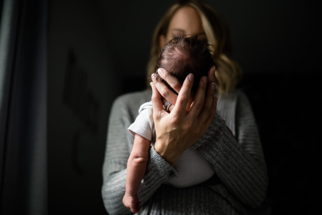 Newborn being held by mom