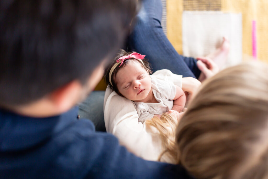 Newborn seen between mom's and dad's heads