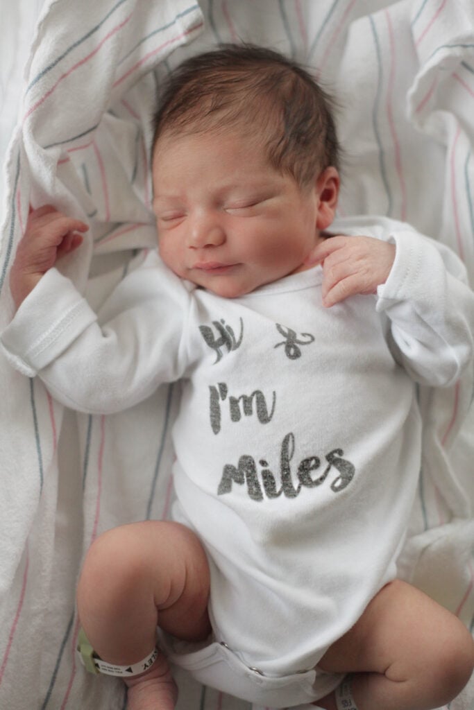 Newborn with name onesie