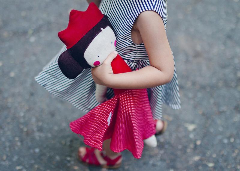Girl carrying a doll