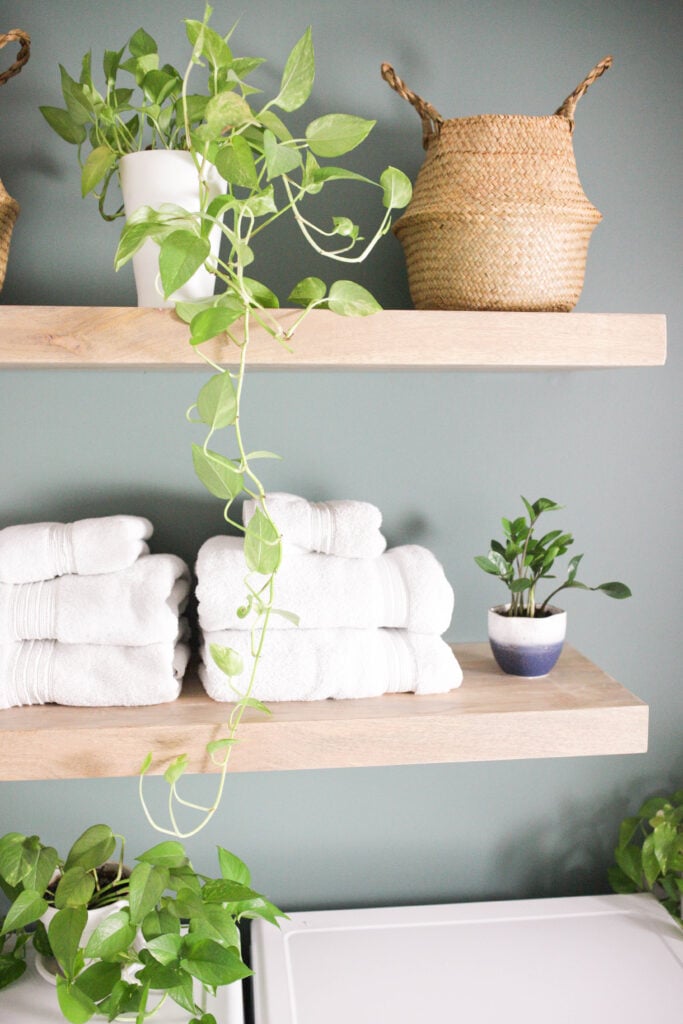 Floating wood shelves in a laundry room