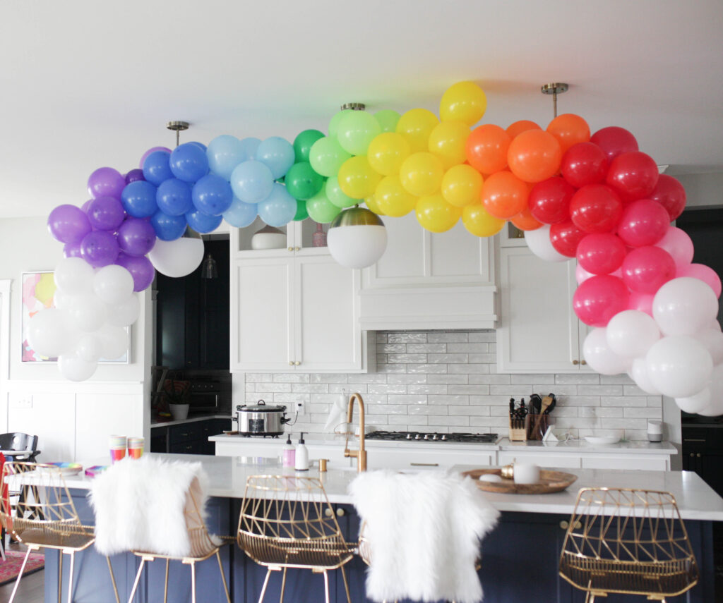rainbow balloon garland in a kitchen