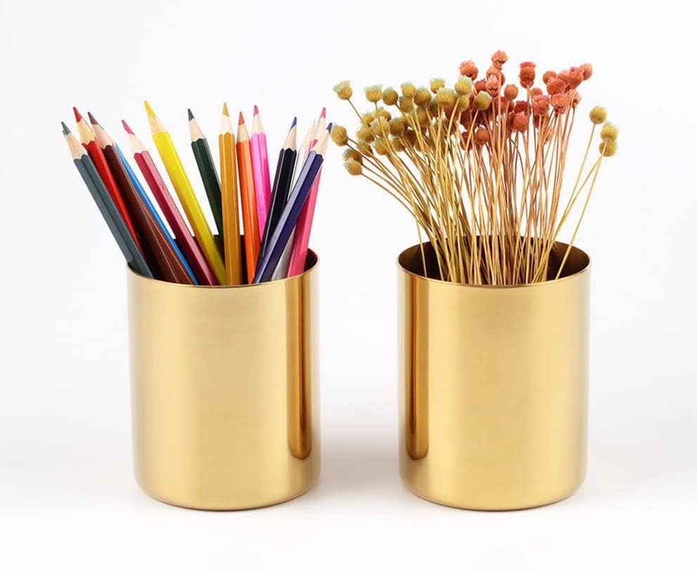 Gold pencil cups holding colored pencils and flowers