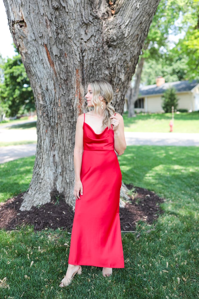 Woman in red cowl neck dress