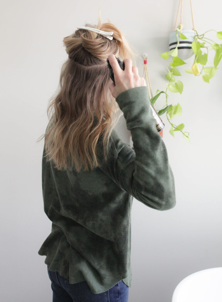 spraying roots with dry shampoo